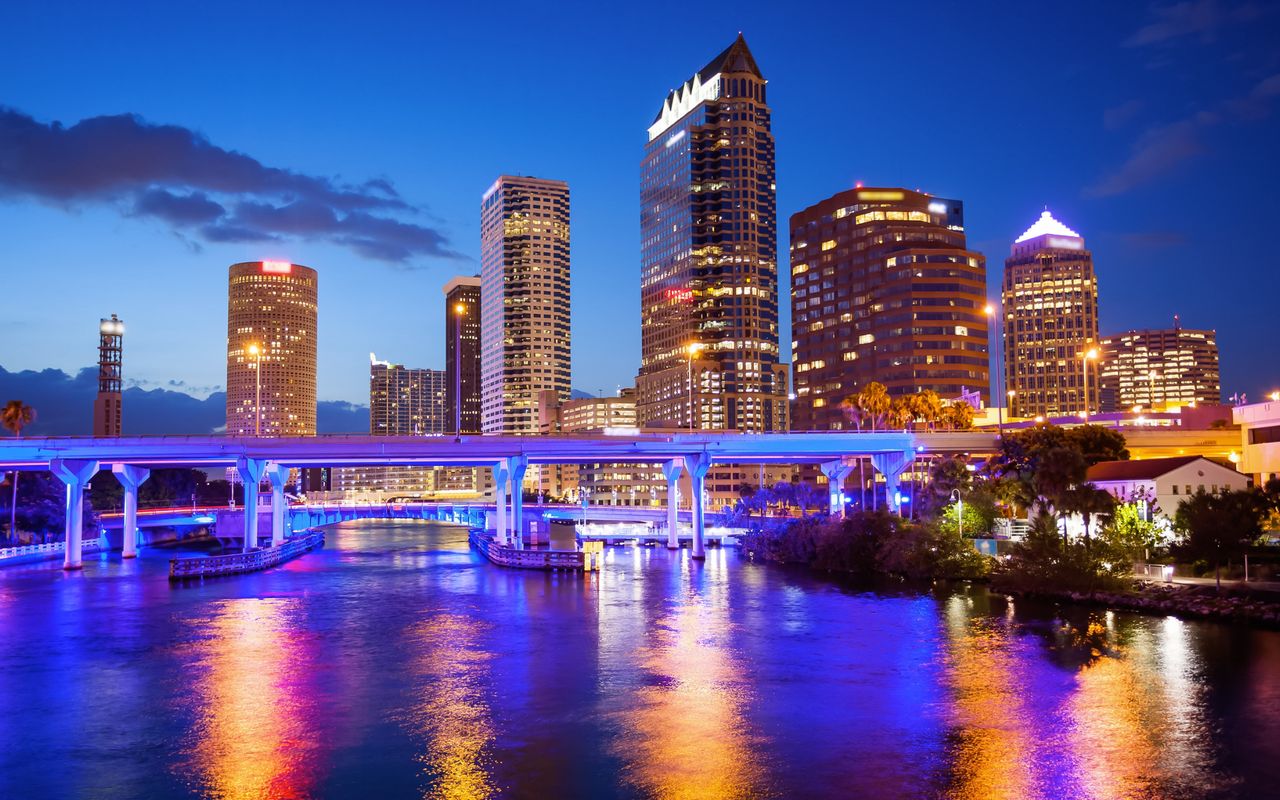 Downtown Tampa skyline at night, lit up over the Hillsborough River